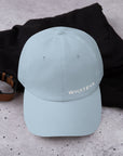 Unisex Classic baseball cap in light blue with embroidered WHATEVR logo, front view