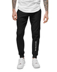 Men's essential slim fit sweatpants in black, front view.