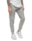 Men's essential slim fit sweatpants in heather grey, front view.