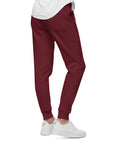 Men's essential slim fit sweatpants in maroon, side view.