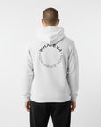 Men's premium heavyweight hoodie in white heather with "Confidence Worn" text, back view.