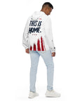 Person wearing a white hoodie with 'This is Home' text and red paint splatter design on a white background