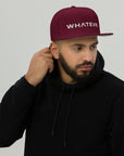 Unisex Unbothered snapback hat in red with embroidered WHATEVR text, front view
