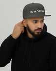 Unisex Unbothered snapback hat in gray with embroidered WHATEVR text, front view