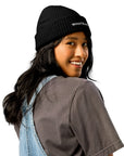 Unisex WHATEVR beanie in black with embroidered detailing, front view