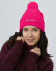 Unisex Signature pom pom knit beanie in pink with embroidered WHATEVR text, front view
