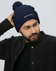 Unisex Signature pom pom knit beanie in blue with embroidered WHATEVR text, front view