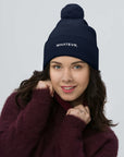 Unisex Signature pom pom knit beanie in blue with embroidered WHATEVR text, front view