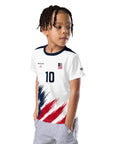 Child wearing a white sports jersey with red and blue design on a white background