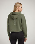 Women's cropped hoodie in green with "WHATEVR" text, back view.