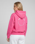 Women's premium heavyweight hoodie in pink with "Confidence Worn" text, back view.