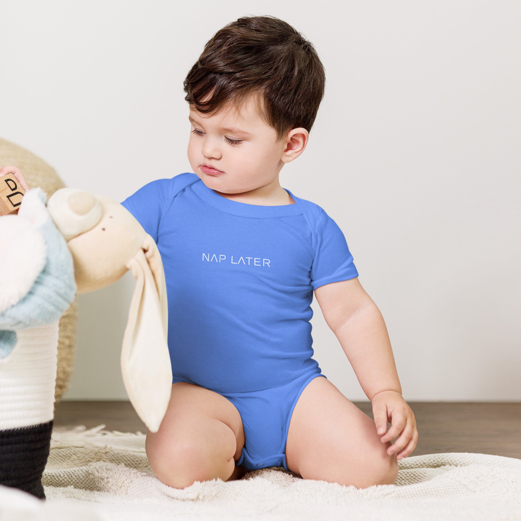 Baby short sleeve bodysuit in blue with "Nap Later" text, front view.