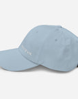 Unisex Classic baseball cap in light blue with embroidered WHATEVR logo, side view