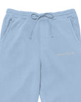 Men's essential relaxed sweatpants in blue with embroidered detailing, front view.