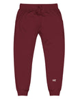 Men's essential slim fit sweatpants in maroon, front view.