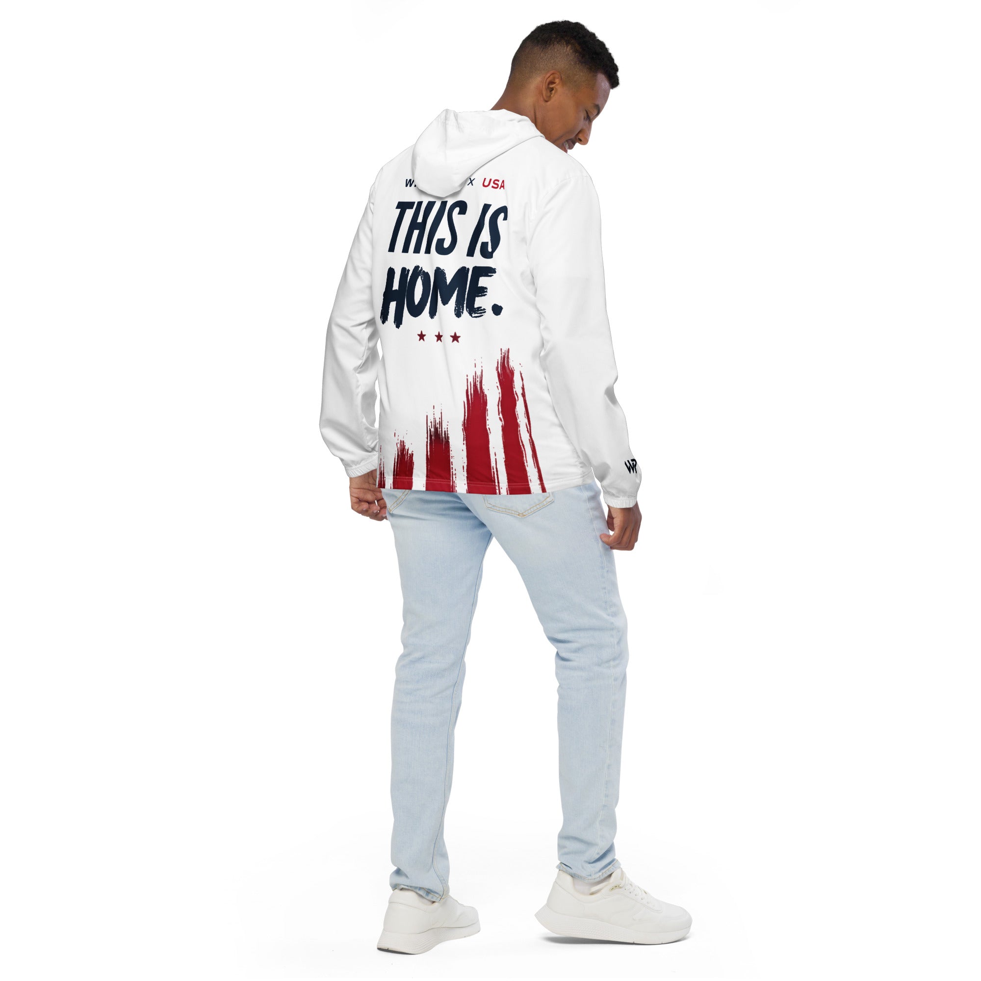 Person wearing a white hoodie with 'This is Home' text and red paint splatter design on a white background