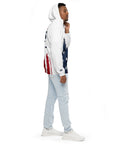 Person wearing a white hoodie with American flag design and light blue jeans on a white background