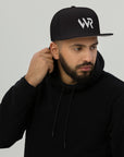 Unisex Signature snapback hat in black with embroidered WR logo, front view