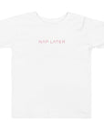Toddler girl's t-shirt in white with "Nap Later" text, front view.