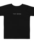 Toddler t-shirt in black with "Tiny Boss" text, front view.