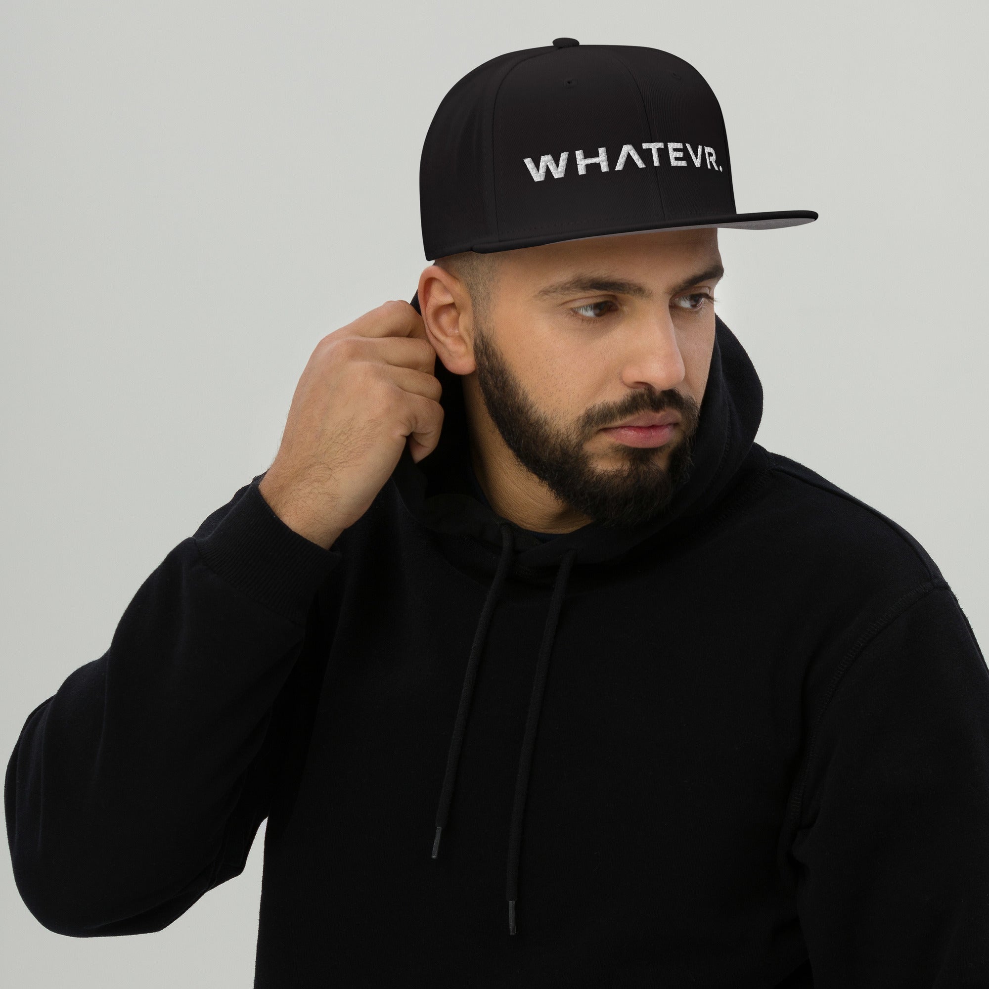 Unisex Unbothered snapback hat in black with embroidered WHATEVR text, front view