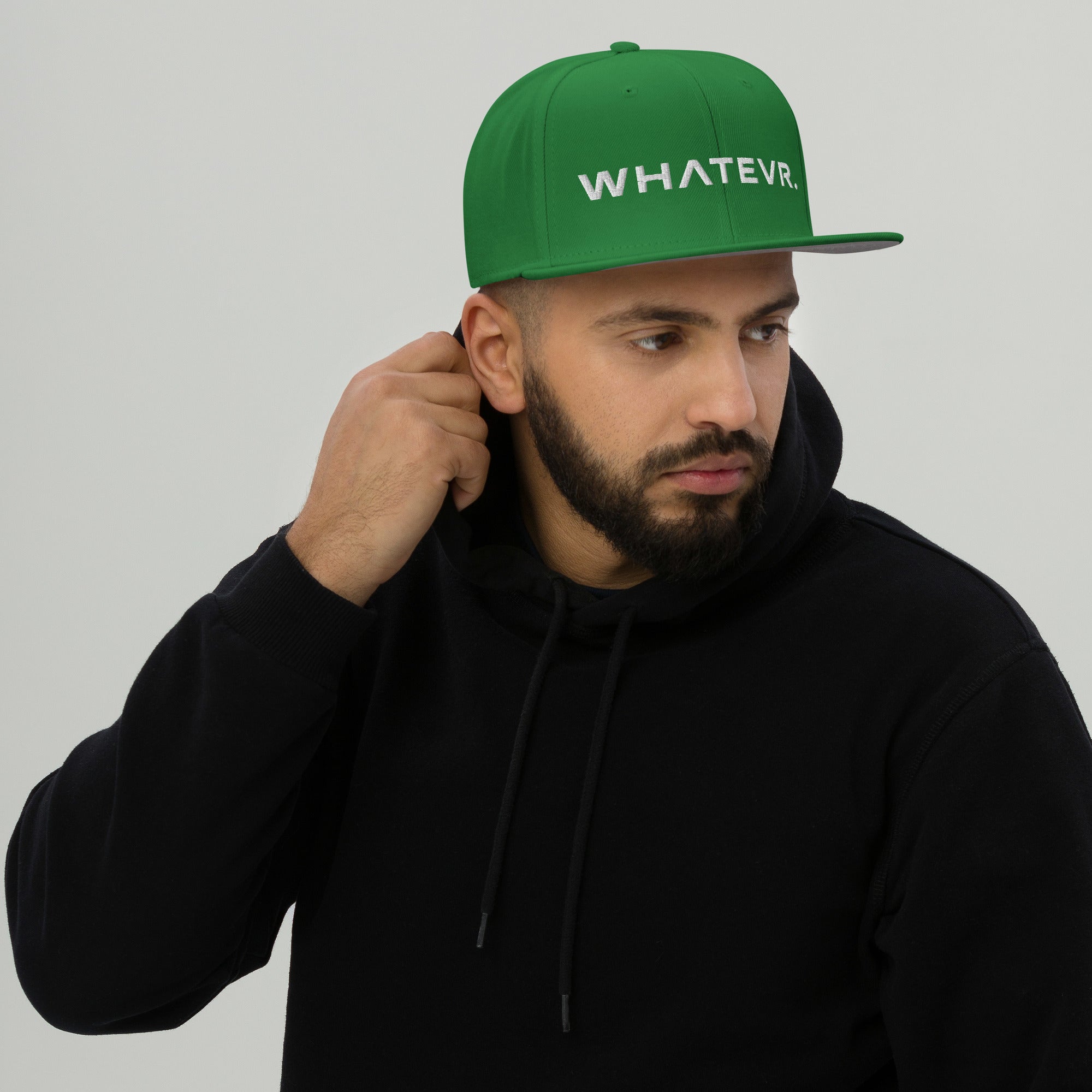 Unisex Unbothered snapback hat in green with embroidered WHATEVR text, front view