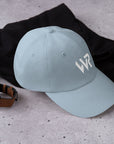 Unisex Classic baseball cap in light blue with embroidered WHATEVR logo, front view