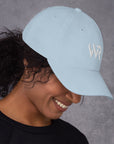 Unisex Classic baseball cap in light blue with embroidered WHATEVR logo, front view