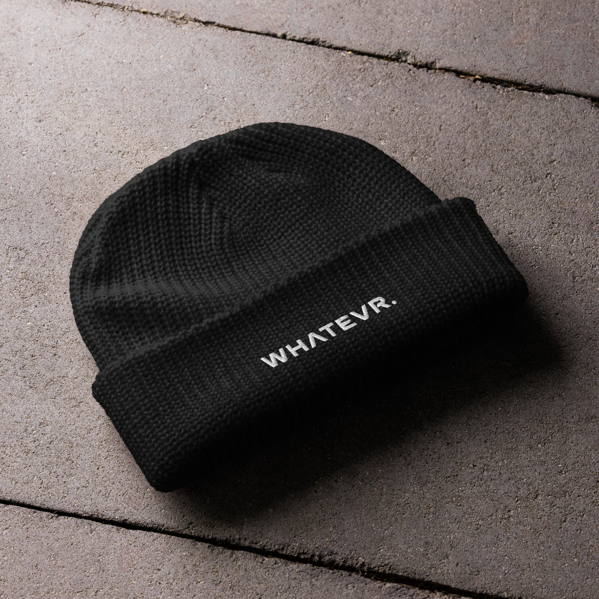 Unisex WHATEVR beanie in black with embroidered detailing, front view