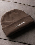Unisex WHATEVR beanie in brown with embroidered detailing, front view