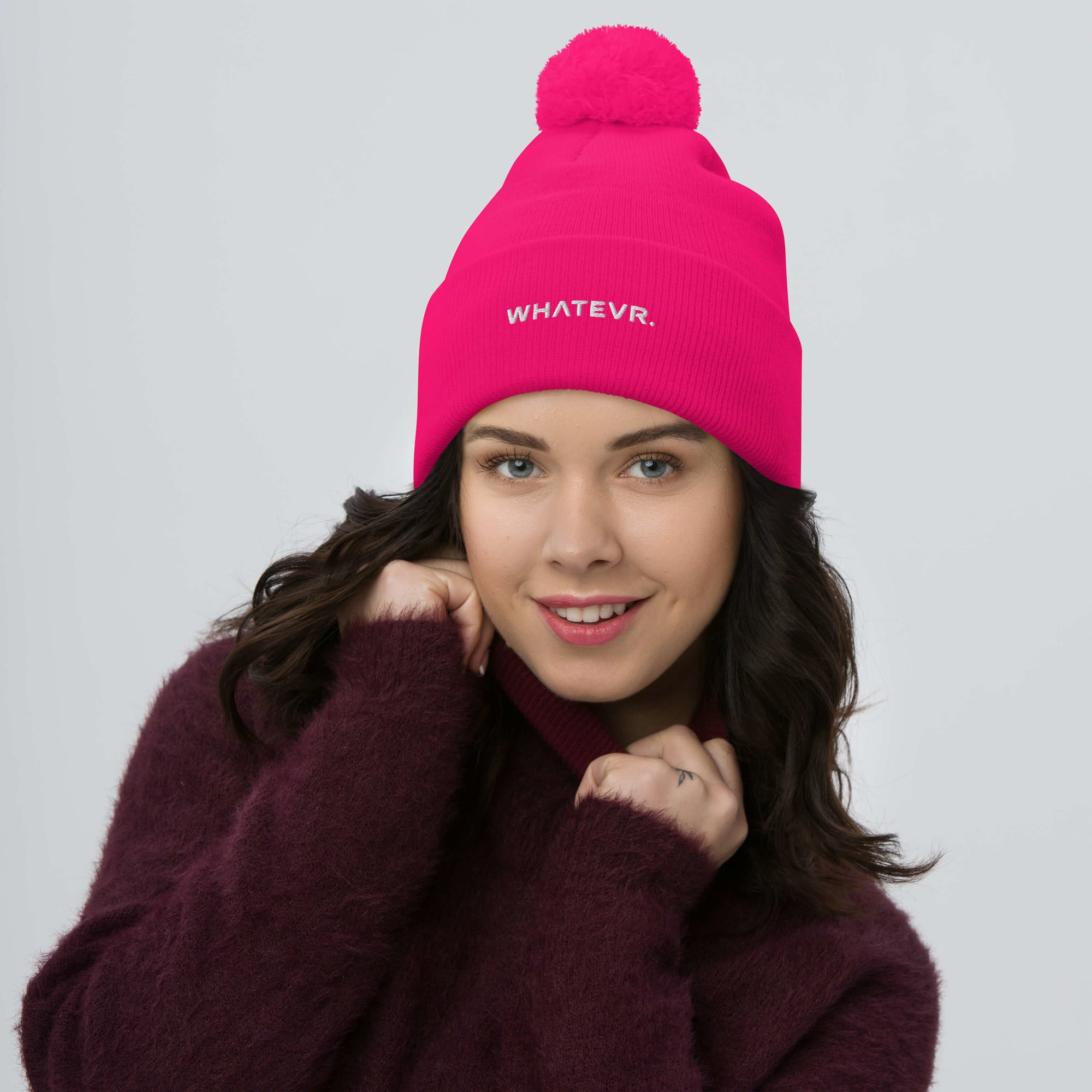 Unisex Signature pom pom knit beanie in pink with embroidered WHATEVR text, front view