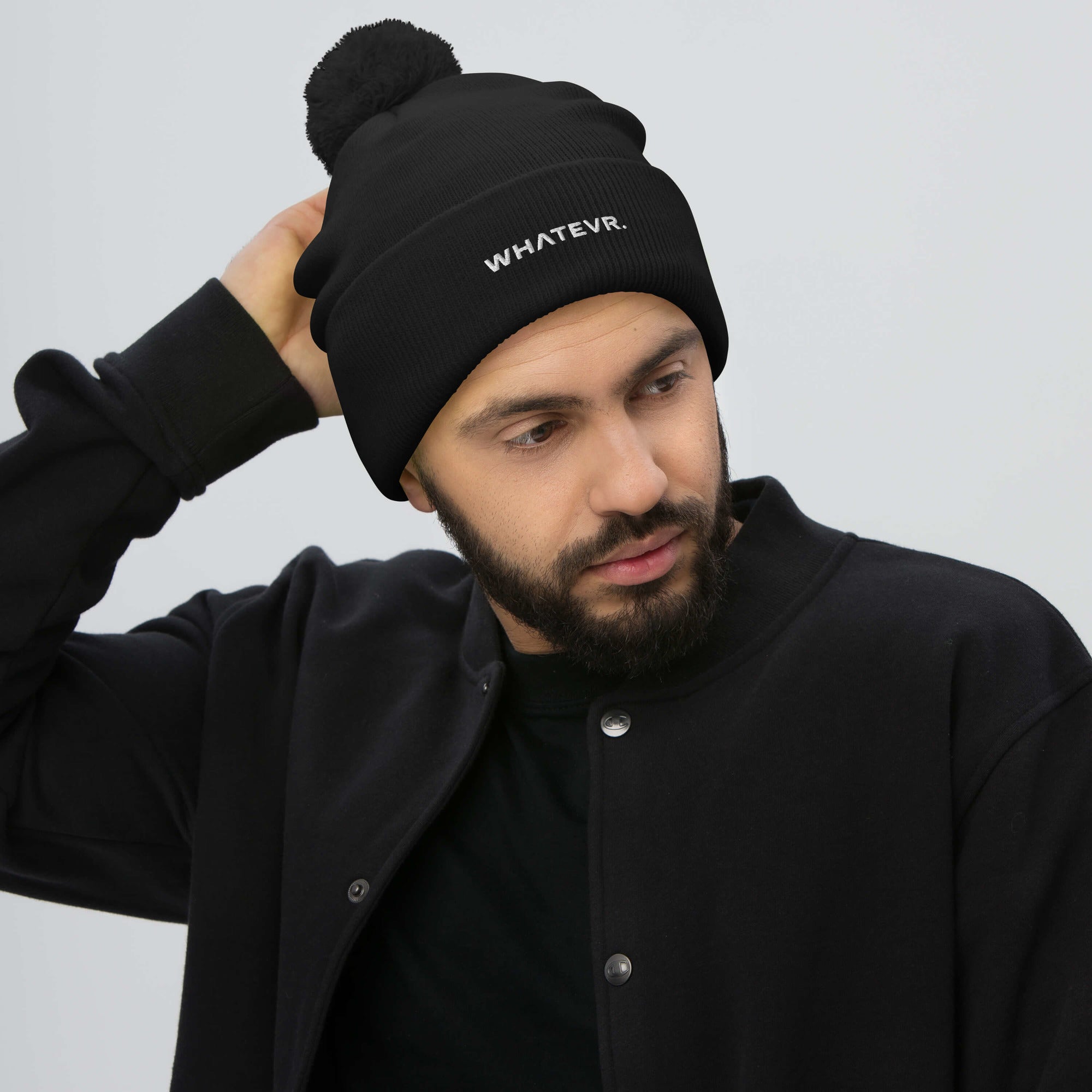 Unisex Signature pom pom knit beanie in black with embroidered WHATEVR text, front view