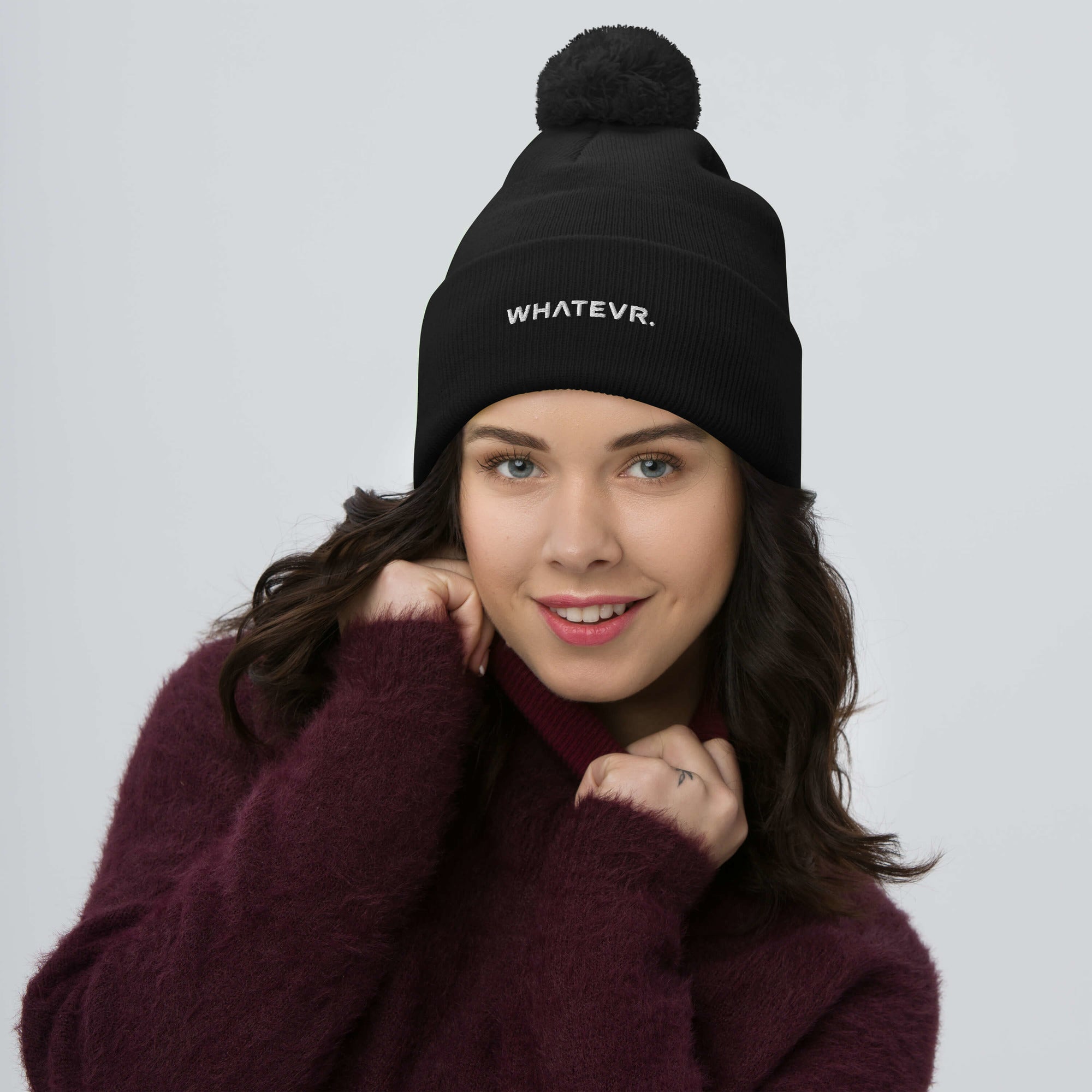Unisex Signature pom pom knit beanie in black with embroidered WHATEVR text, front view