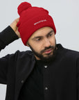 Unisex Signature pom pom knit beanie in red with embroidered WHATEVR text, front view