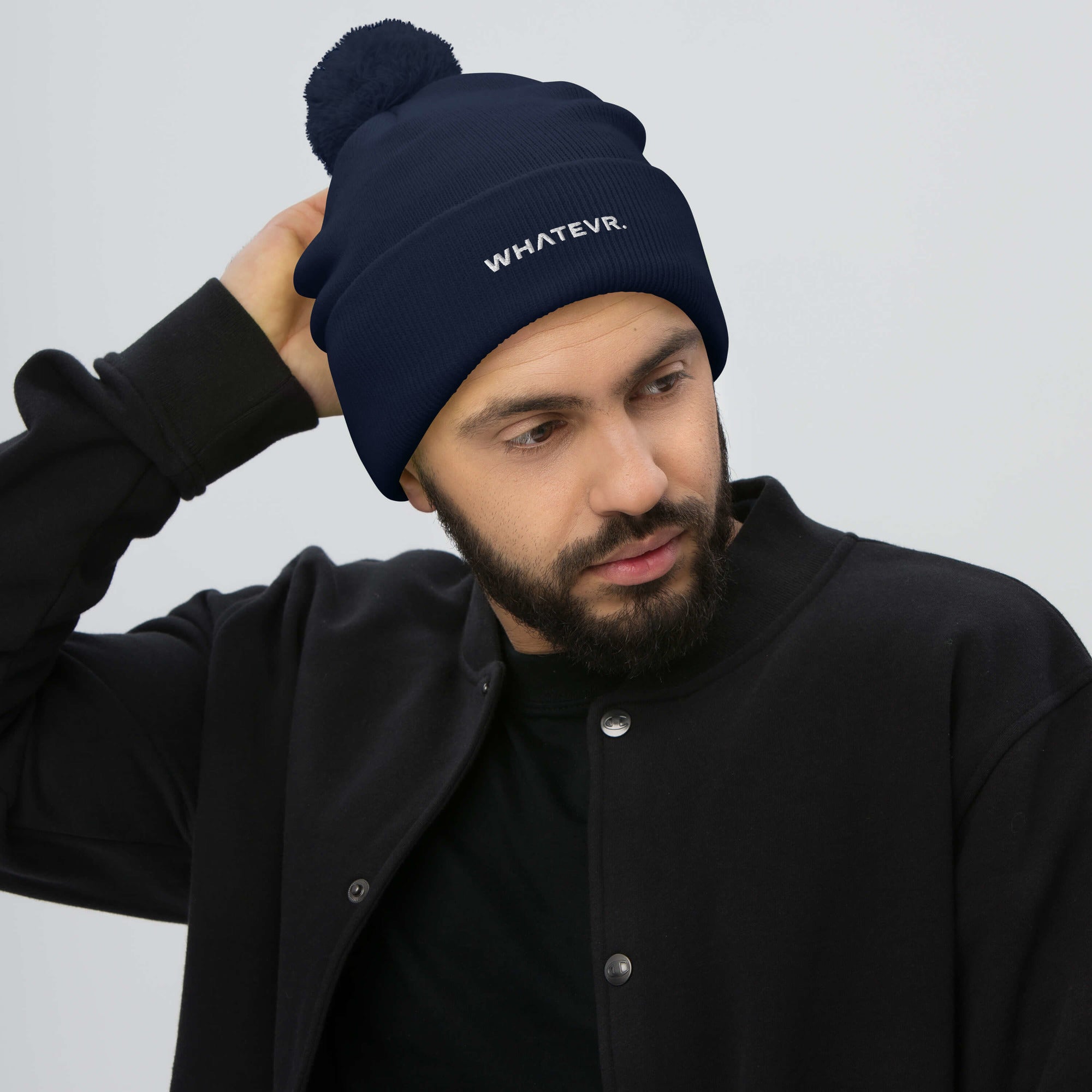Unisex Signature pom pom knit beanie in blue with embroidered WHATEVR text, front view
