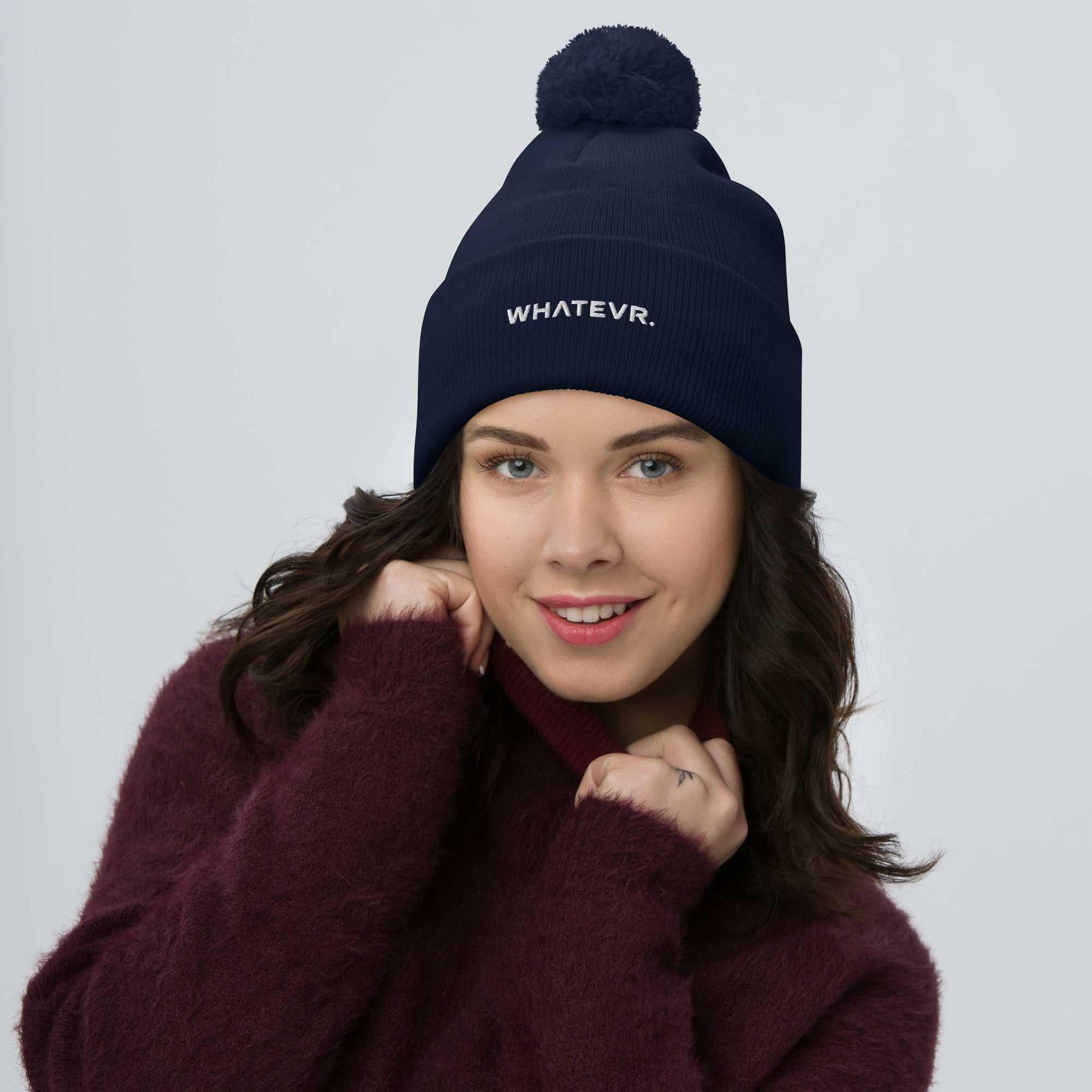 Unisex Signature pom pom knit beanie in blue with embroidered WHATEVR text, front view
