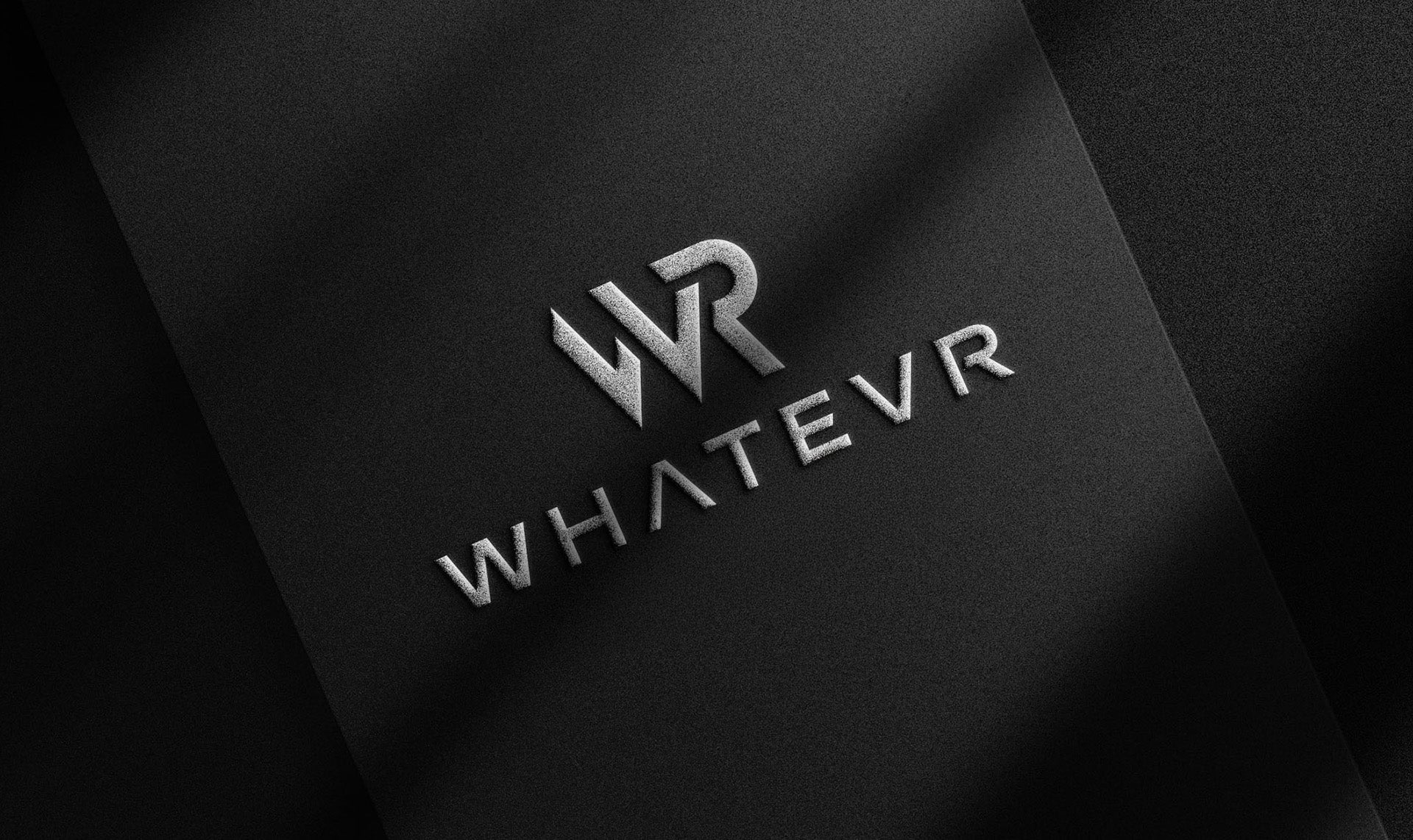 Logo of 'WHATEVR' on a black textured background. WHATEVR premium essentials  for everyday comfort and confidence