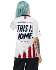 Person wearing a white sports jersey with text and red and blue design on a white background