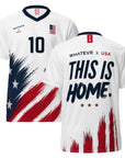 White sports jersey with American flag design and 'This is Home' text on a white background