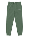 Women's essential relaxed sweatpants in green with embroidered detailing, front view.
