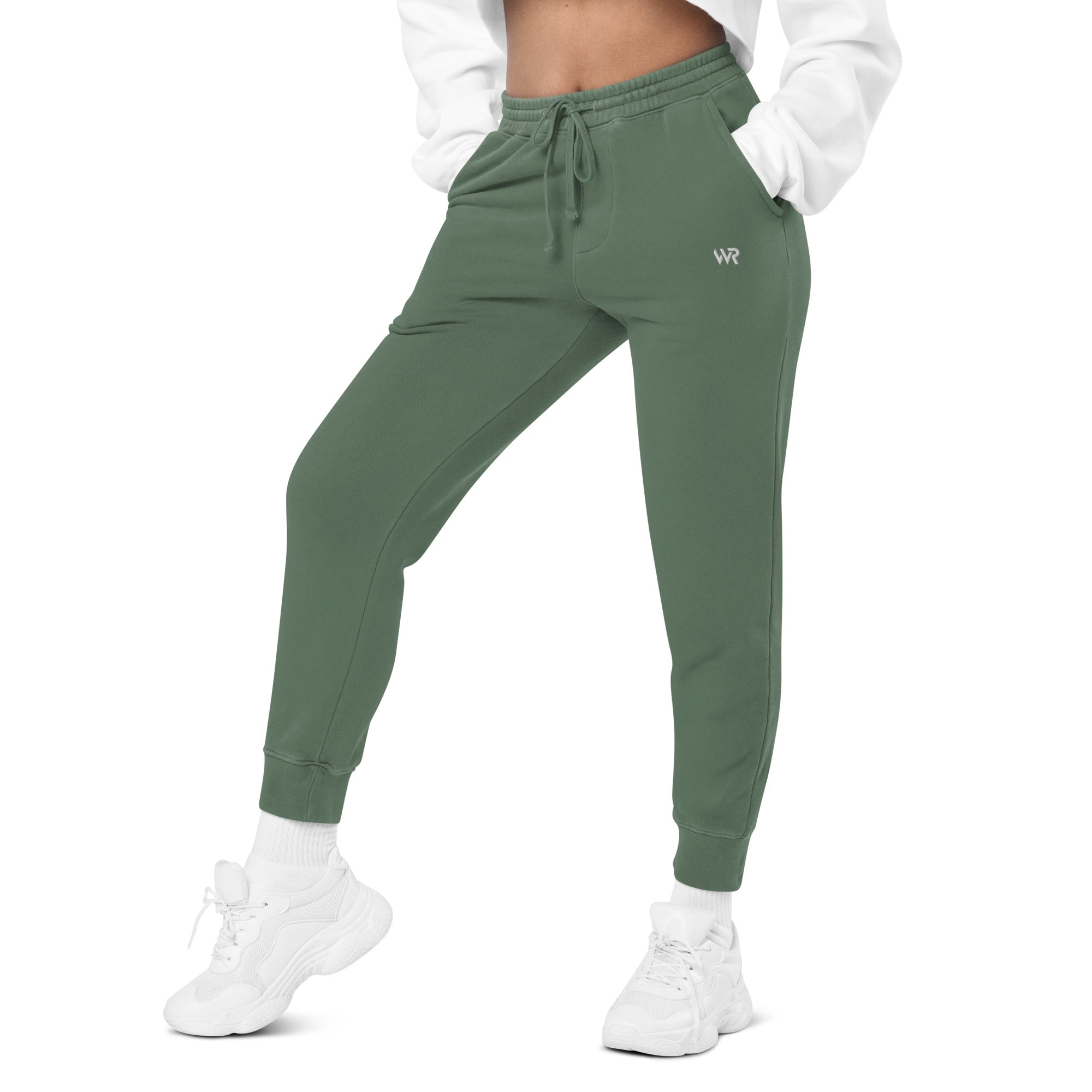 Women's essential relaxed sweatpants in green with embroidered detailing, front view.