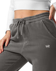 Women's essential relaxed sweatpants in grey with embroidered detailing, front view.