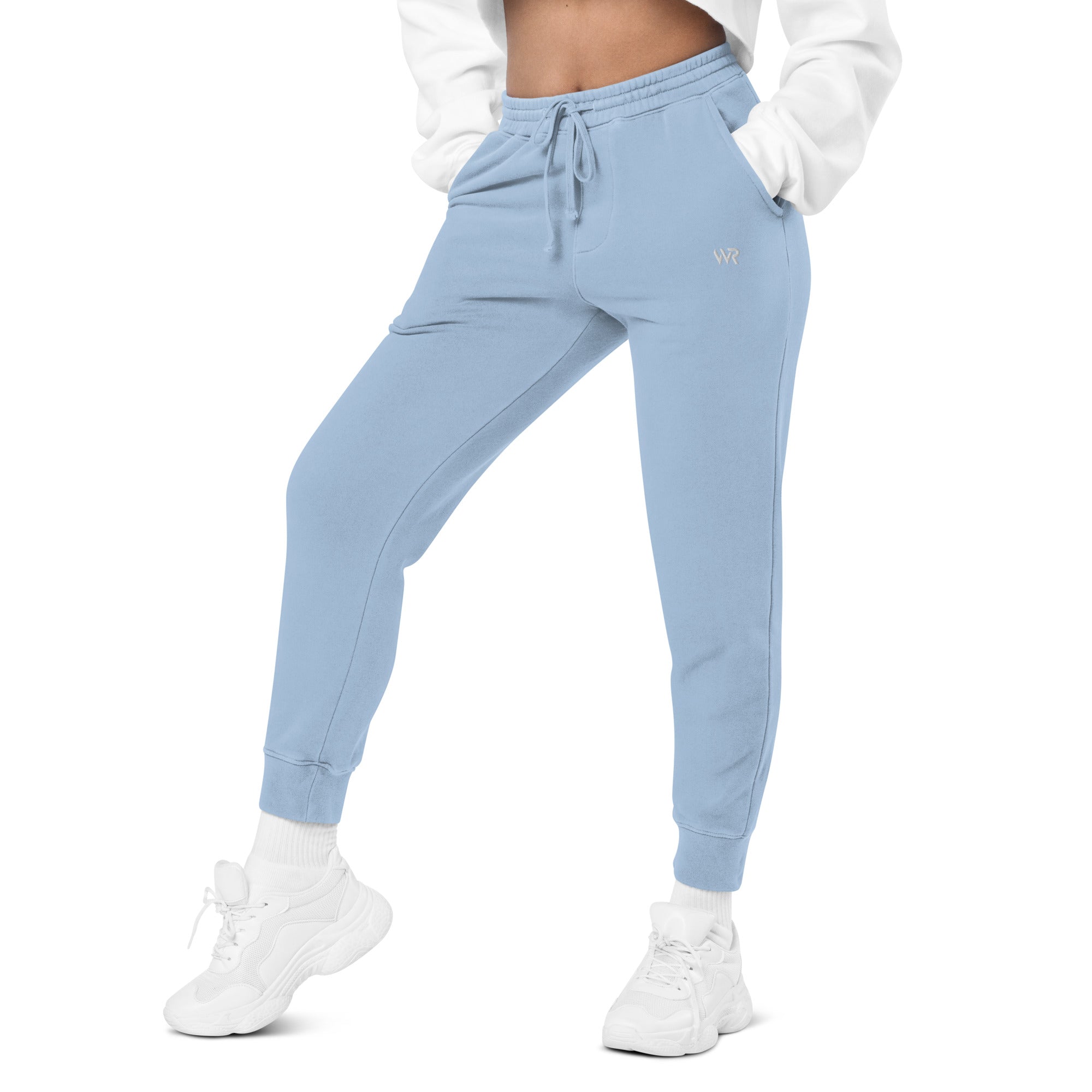 Women's essential relaxed sweatpants in light blue with embroidered detailing, front view.