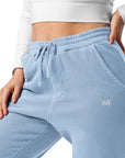 Women's essential relaxed sweatpants in light blue with embroidered detailing, front view.