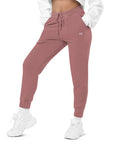 Women's essential relaxed sweatpants in maroon with embroidered detailing, front view.