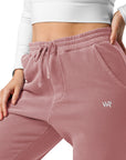 Women's essential relaxed sweatpants in maroon with embroidered detailing, front view.
