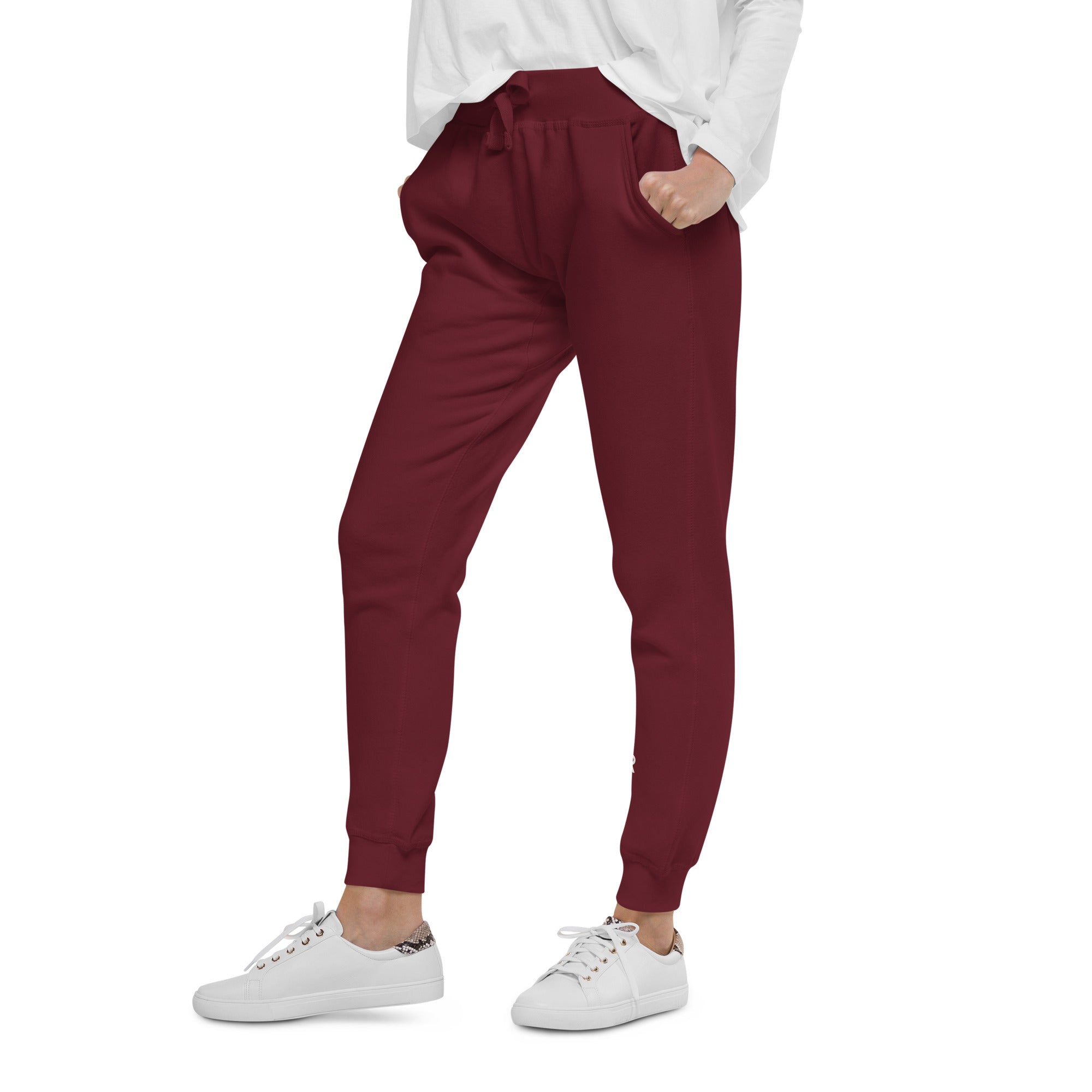 Women's essential slim fit sweatpants in maroon, side view.