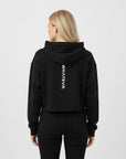 Women's cropped hoodie in black with "WHATEVR" text, back view.