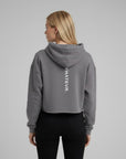 Women's cropped hoodie in grey with "WHATEVR" text, back view.