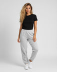 Women's premium heavyweight sweatpants in light grey, front view.